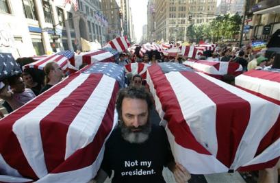 Stanley Sherman of New York helps carry a flag-draped casket past Madison Square Garden during the anti-Bush march organized by United for Peace and Justice in New York Sunday, Aug. 29, 2004, on the eve of the Republican National Convention. The group carried what was described as 1,000 coffins representing U.S. dead in Iraq (news - web sites). (AP Photo/Paul Sancya) 